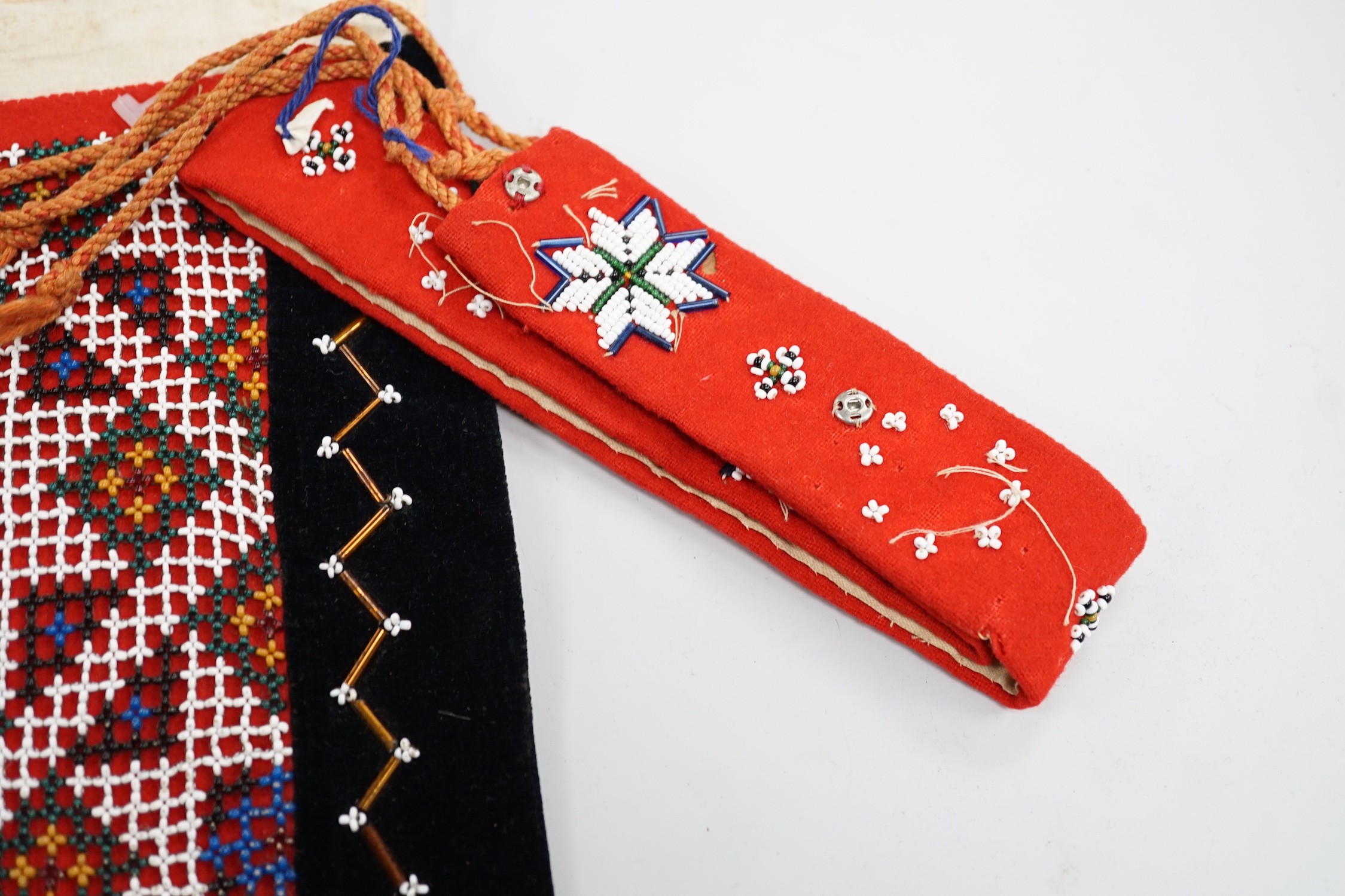 A collection of 19th century Scandinavian beadwork, worked in white and coloured geometric designs on red wood backing, (5)